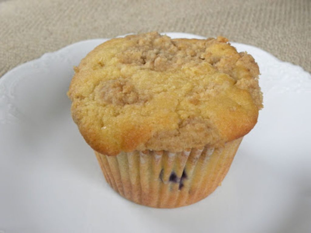 blueberry lemon muffin on a white plate