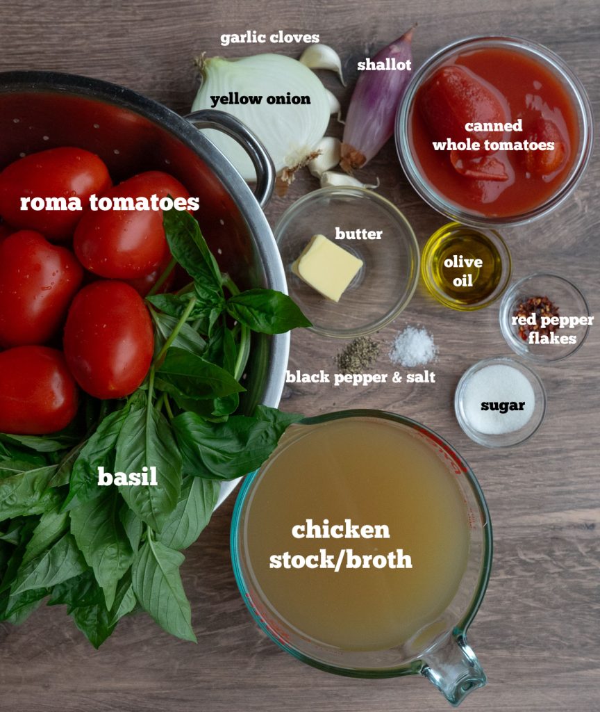 ingredients for roasted tomato basil soup on a butcher block counter top