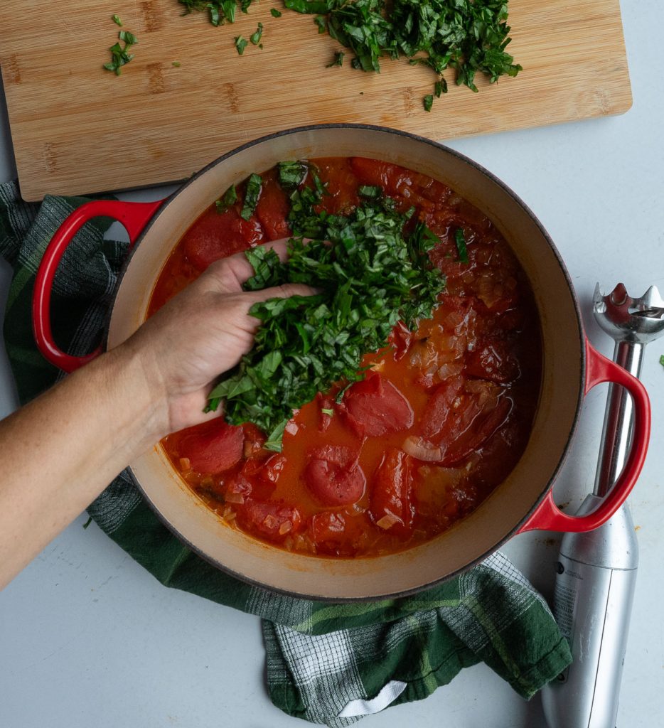 Adding chopped basil to soup 