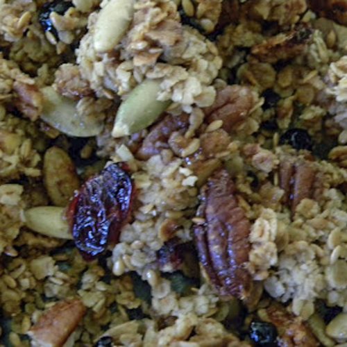 close up photo of homemade granola with pepitas, pecans, oats and dried fruit