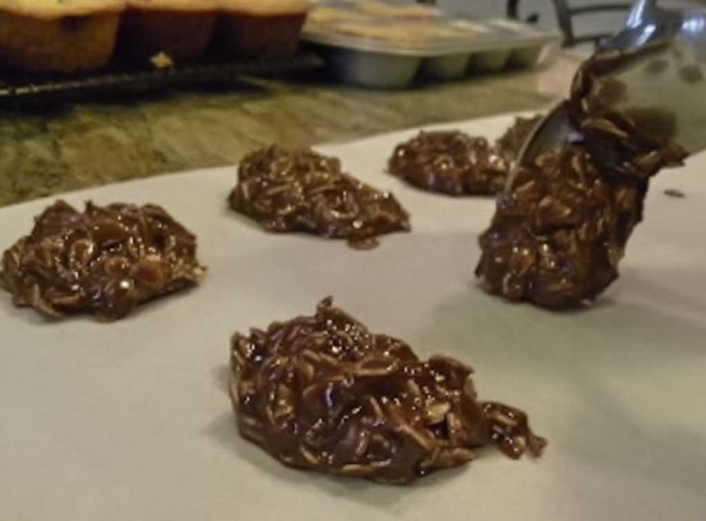 dropping no-bake cookie dough out on to parchment paper