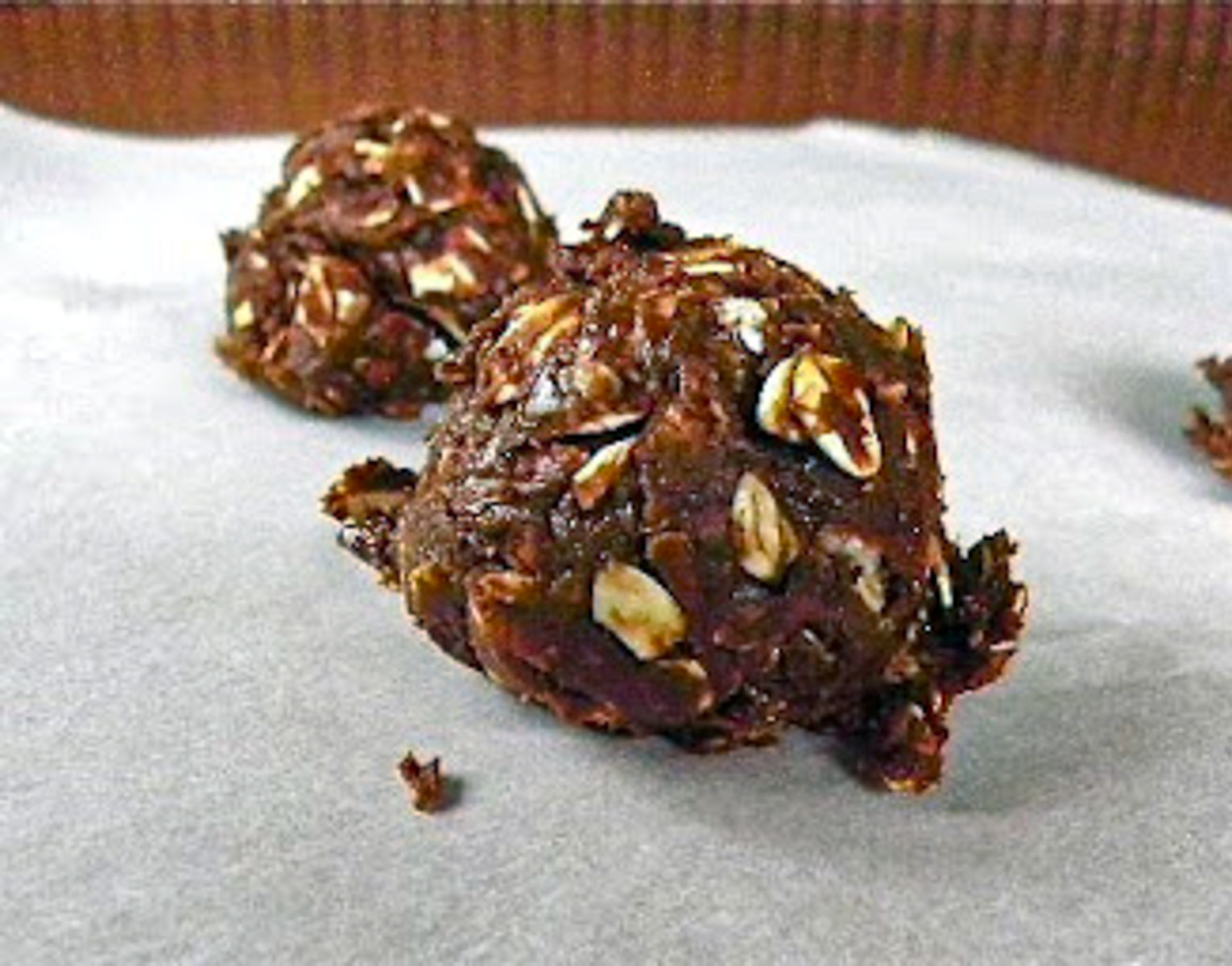 no-make cookie scooped out with cookie scooper into a round ball on parchment paper