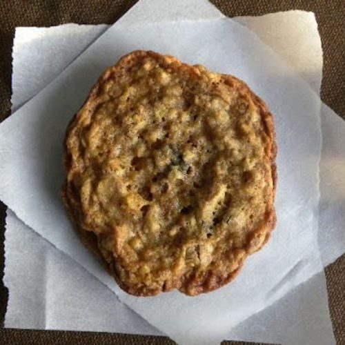 one granola cookie on a piece of parchment paper