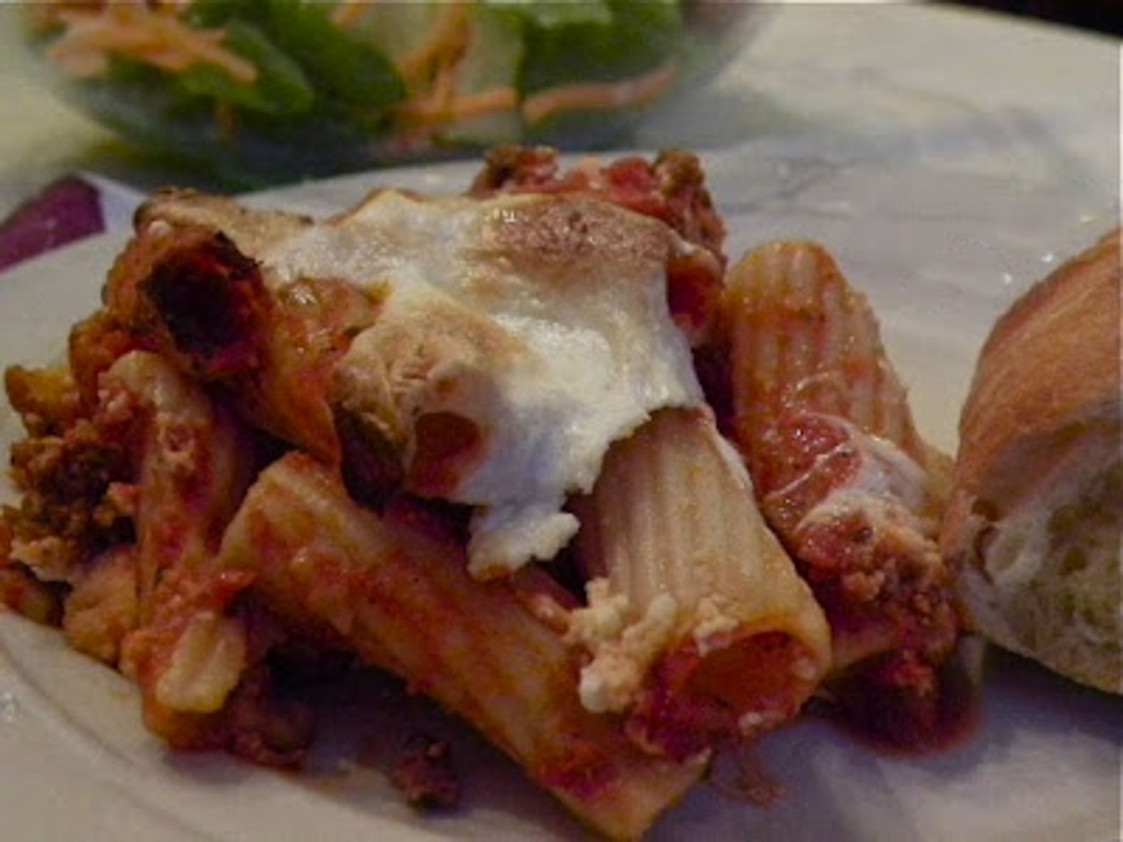 scoop of mostaccioli pasta on a white plate