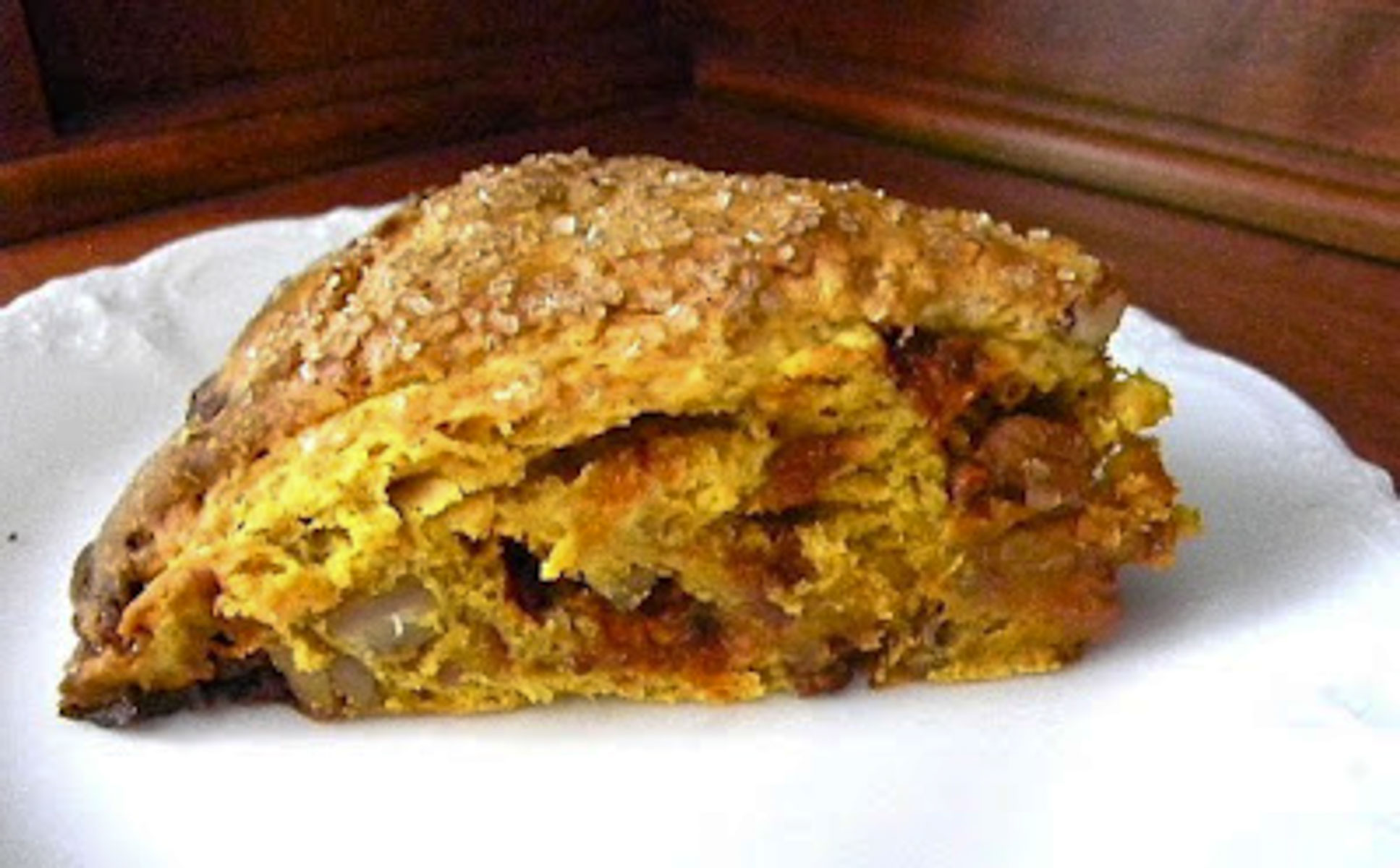 loaded pumpkin scone on a white plate