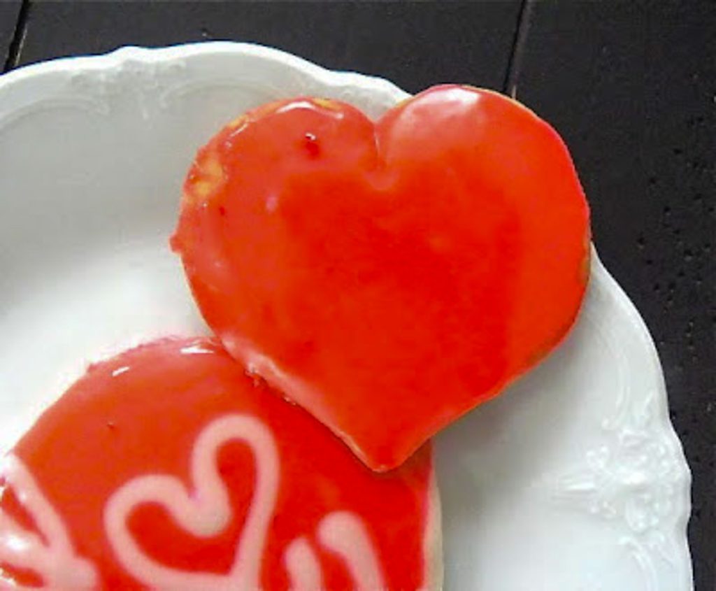 heart shaped sugar cookie decorated with red icing