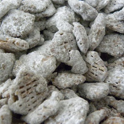 Puppy chow is a no-bake treat made by covering crispex cereal in a chocolate and peanut butter candy coating and tossing it in powdered sugar.