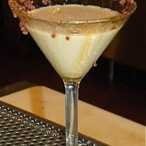 maple bacon martini sittin on the edge of a bar