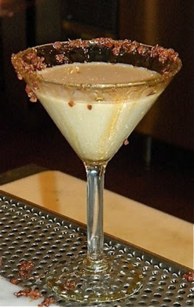 maple bacon martini sittin on the edge of a bar