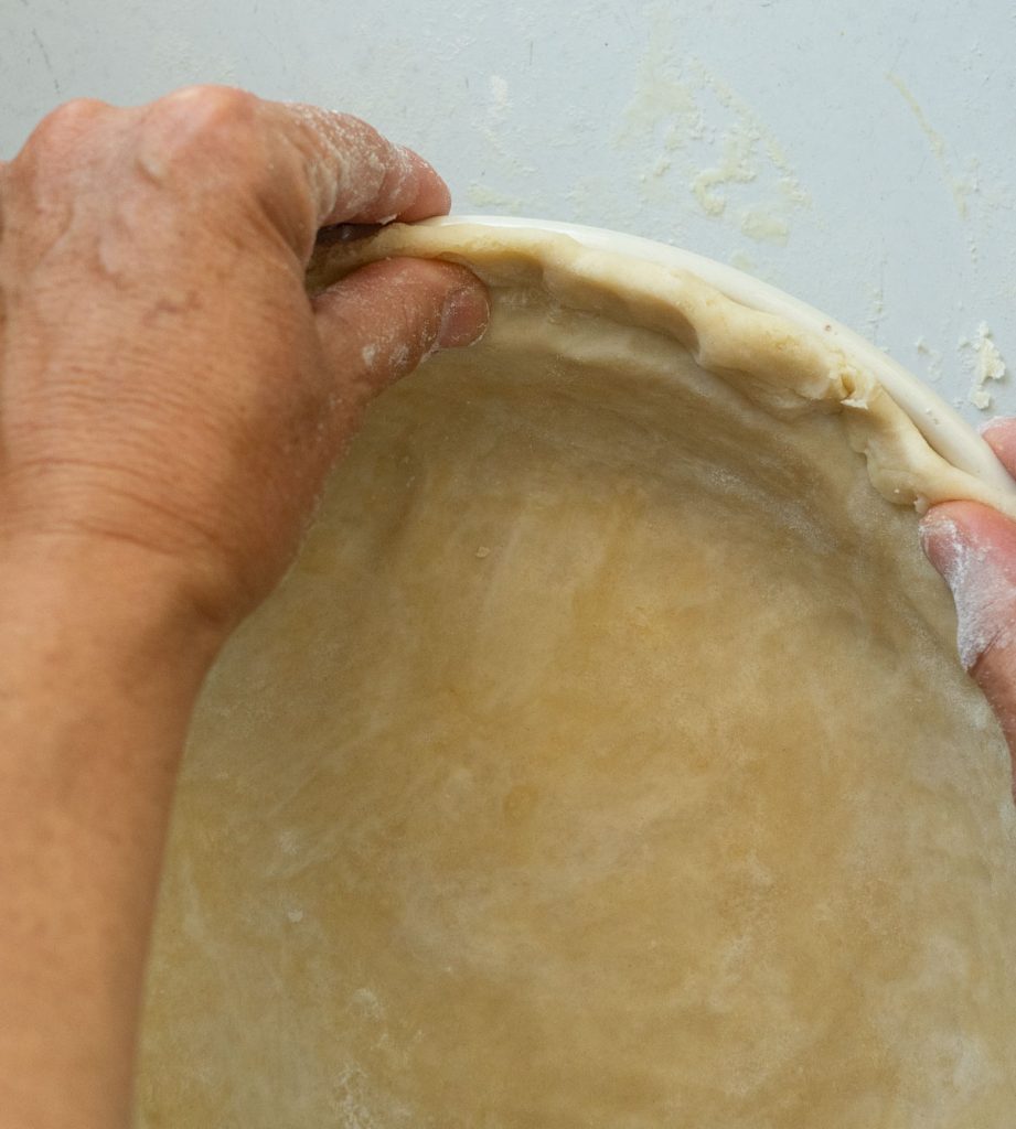 shaping and crimping pie crust in pie plate