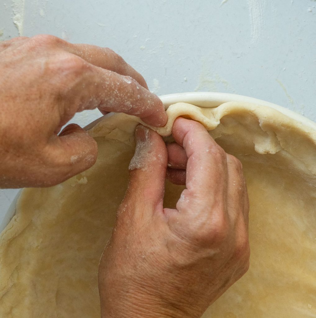 showing how to crimp edges of pie crust