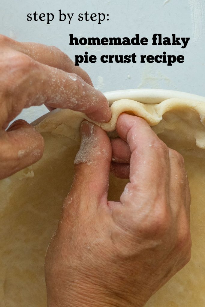 hands crimping a pie crust into a pie plate 