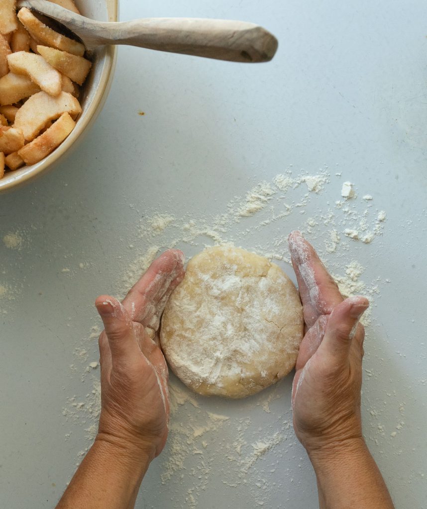 rolling out pie crust.  set pie dough disc on a lightly floured countertop