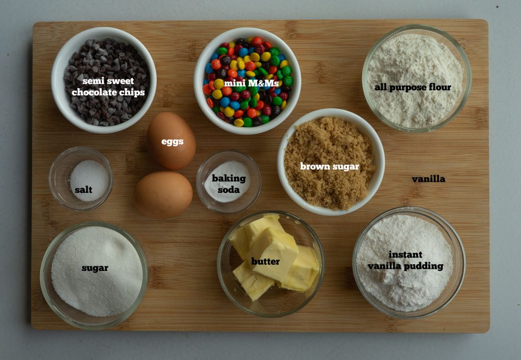 ingredients for soft and chewy chocolate chip cookies on a wooden background