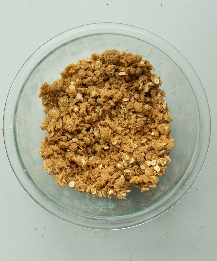 streusel topping in a glass bowl on a gray table