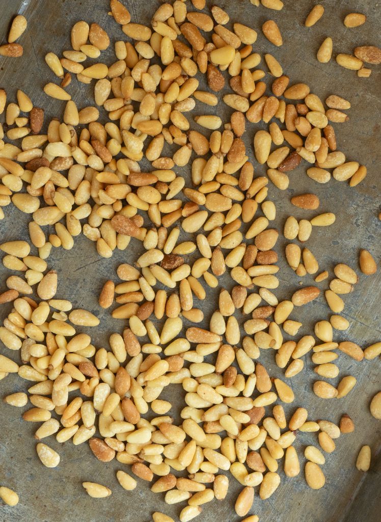 toasted pinenuts on a baking sheet