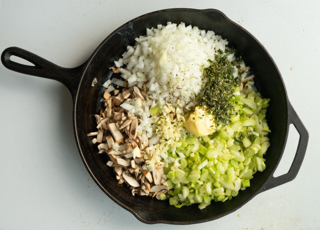 onions, celery, mushrooms, garlic, fresh herbs and fats in a cast iron skillet 