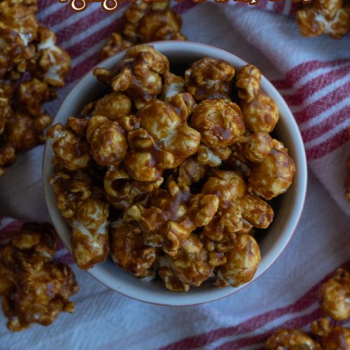 gingerbread caramel corn in a small red dish on a red and white striped cloth