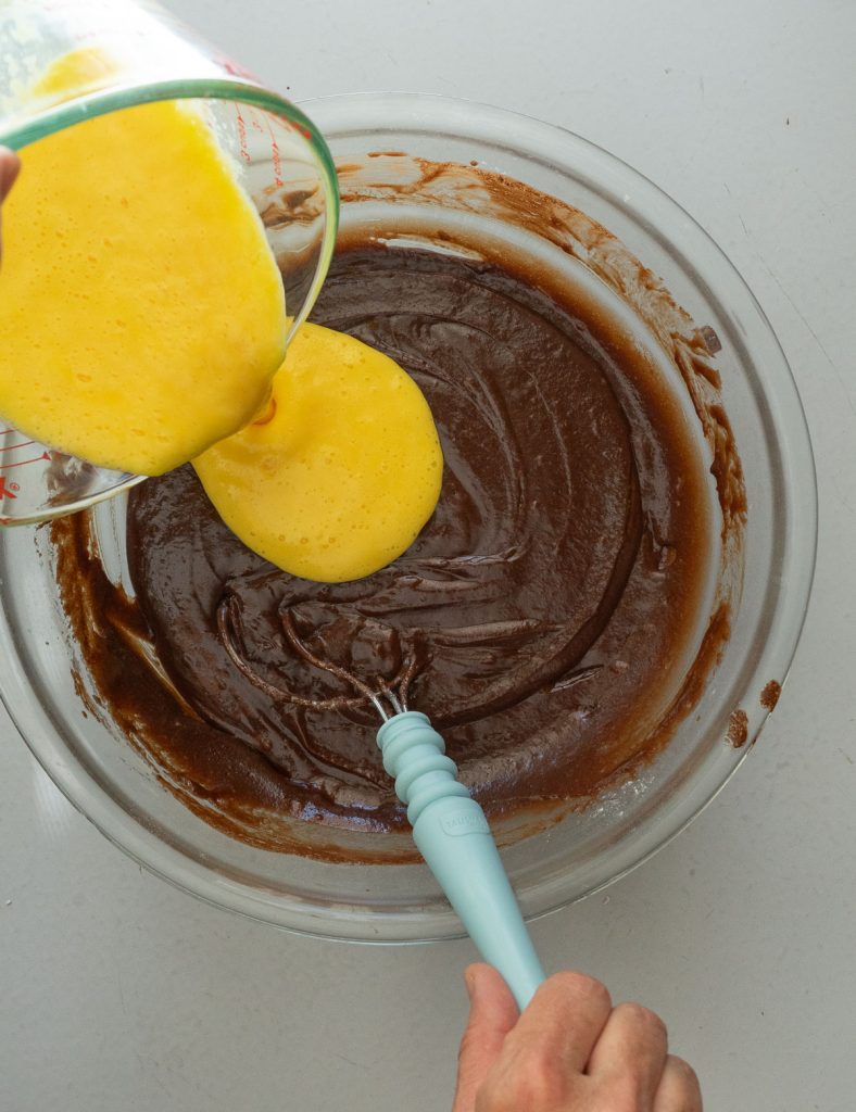 adding egg buttermilk mixture to the cake batter