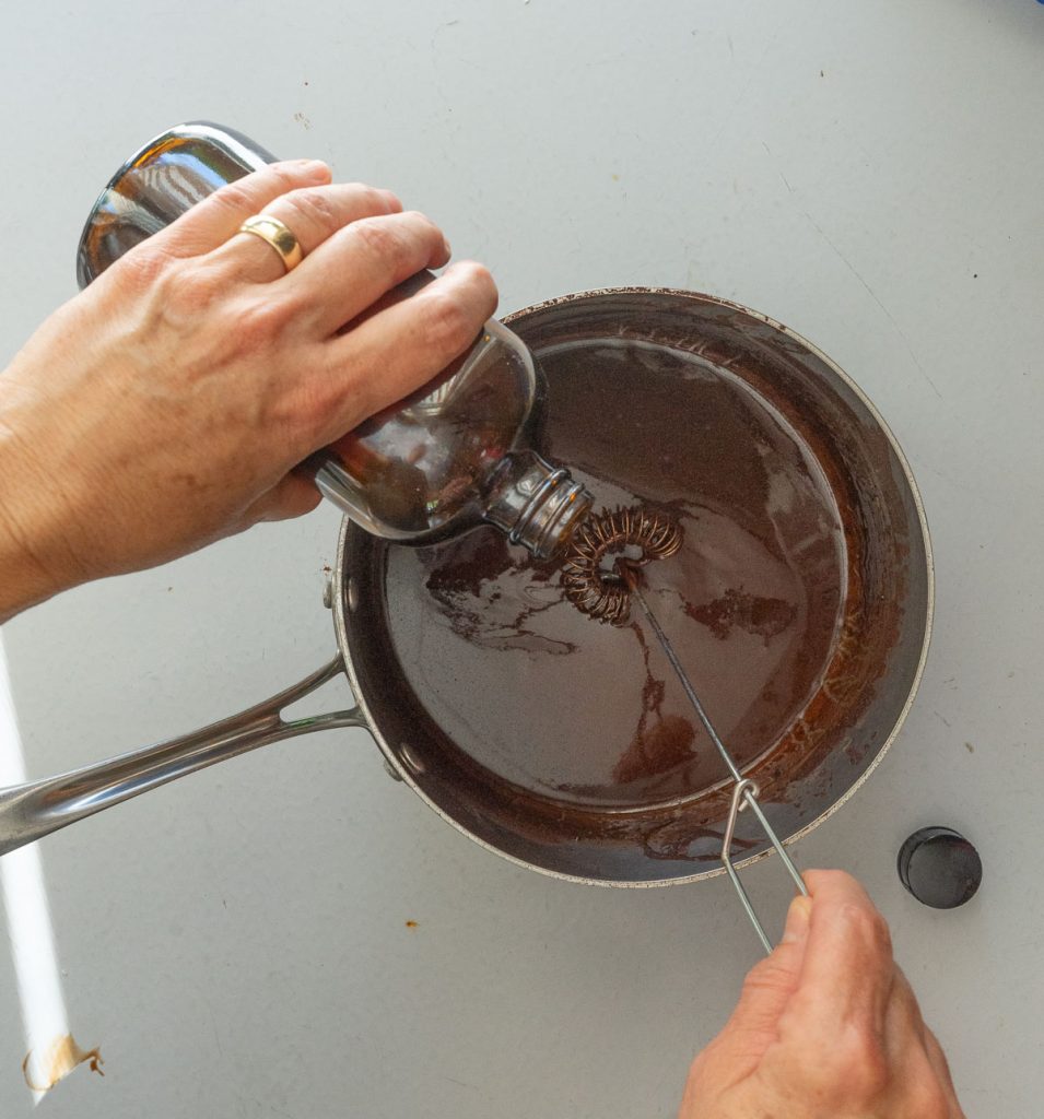 adding vanilla extract to the fudge frosting