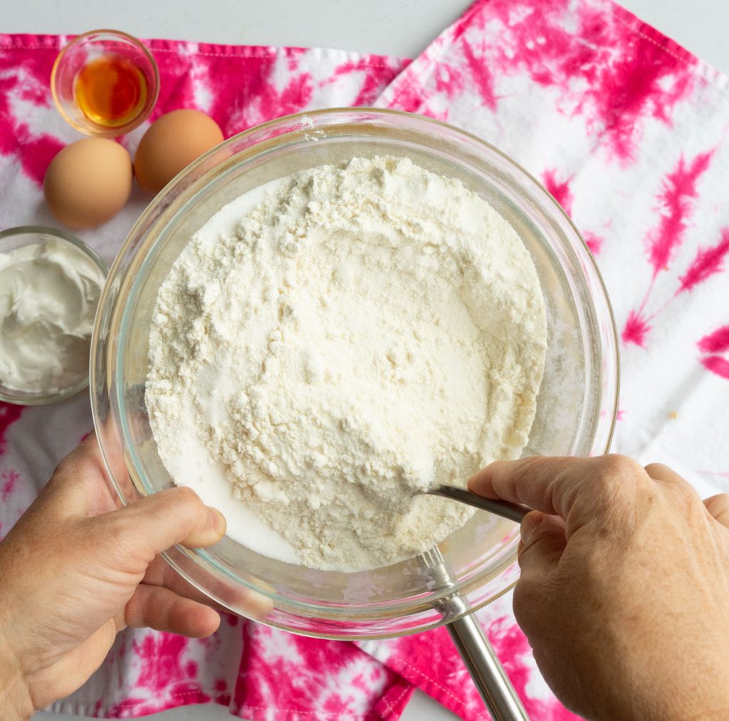 combining dry ingredients in a glass bowl 