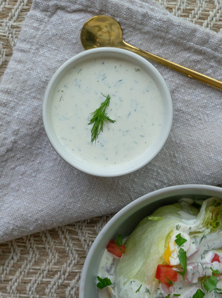 small bowl with homemade buttermilk ranch dressing garnished with dill 